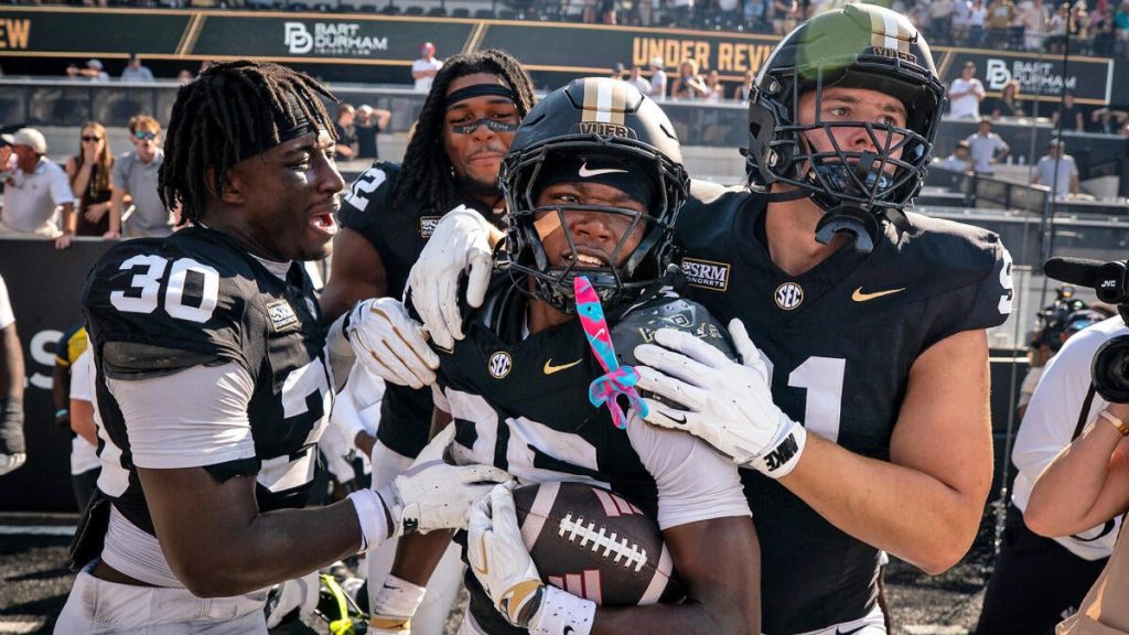 WATCH: Vanderbilt scores miraculous last-second go-ahead touchdown after NC State fumbles intentional safety – cbssports.com